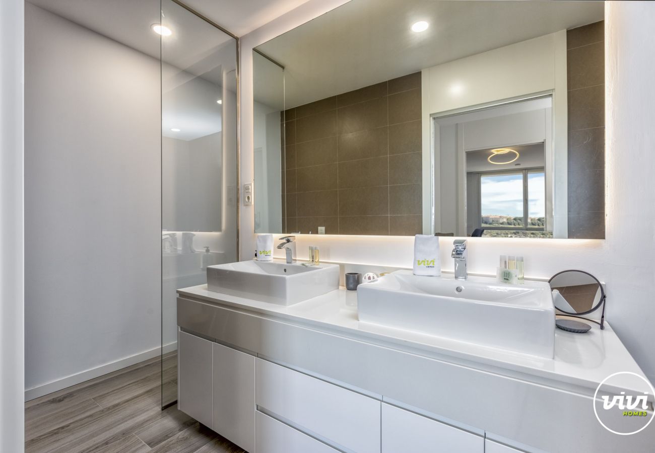 Bathroom with lit mirror