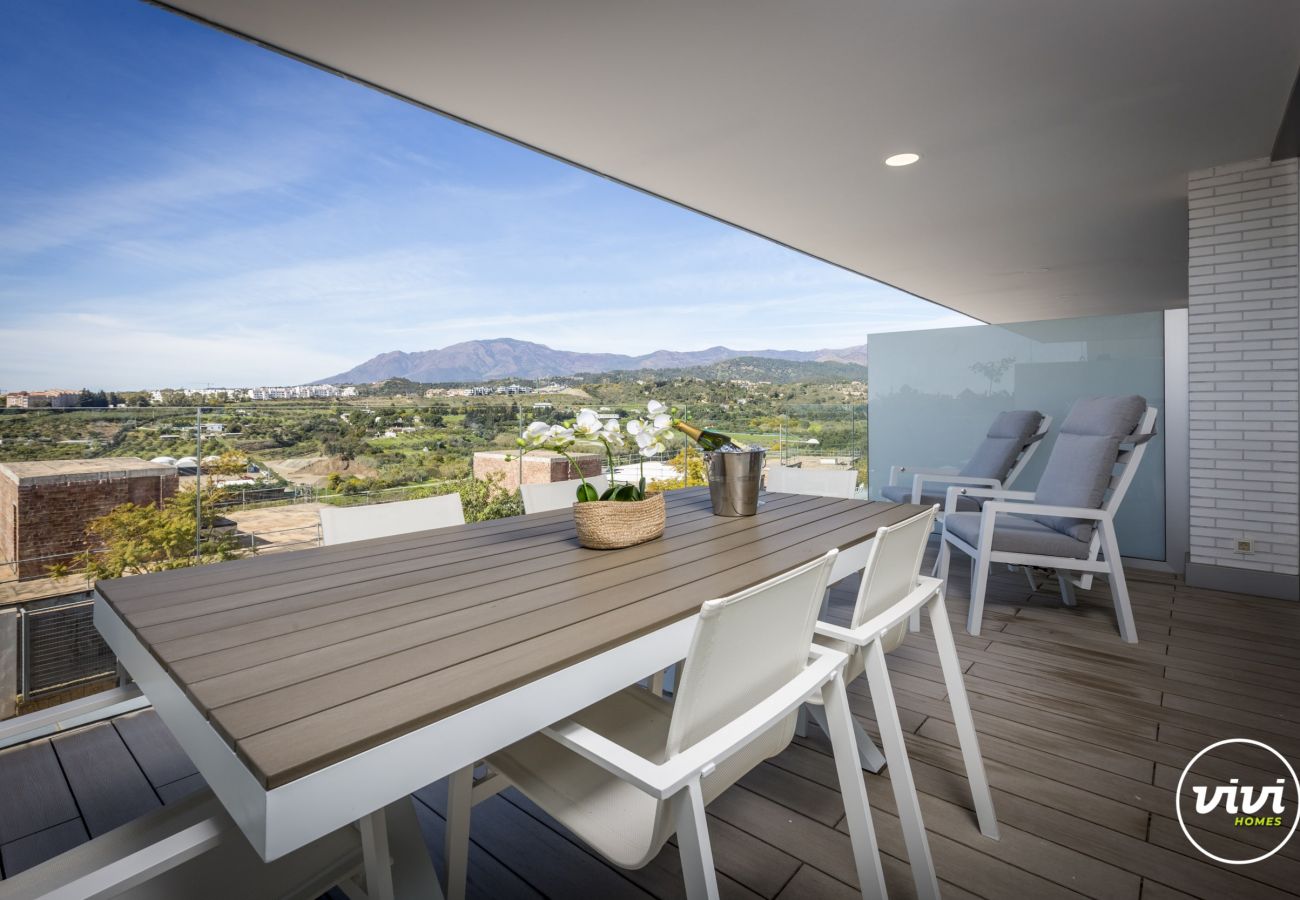 Terrace with dining table and mountain views